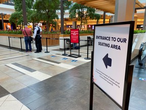 A security guard verifies proof of vaccination at the entrance to a food court during phase one of the Ontario Vaccine Certification Program in Toronto on September 22, 2021.