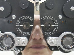 A woman has her eyes checked at an optometrist's office.