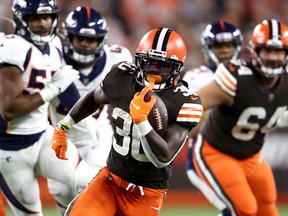 Cleveland Browns running back D'Ernest Johnson # 30 runs with the ball after making a first-quarter pass against the Denver Broncos at FirstEnergy Stadium on October 21, 2021 in Cleveland, Ohio.