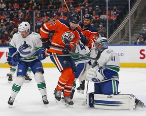 Oilers forward Warren Foegele (37) deflects a shot on Vancouver Canucks goalkeeper Jaroslav Halak (41) during the first period at Rogers Place.