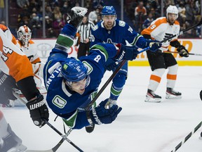 Vancouver Canucks forward Conor Garland bumps into the Philadelphia Flyers in the first period at Rogers Arena.