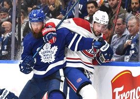 Maple Leafs 'Jake Muzzin (left) fights on the boards with Montreal Canadiens' Josh Anderson during Wednesday's game in Toronto. DAN HAMILTON / USA TODAY SPORTS