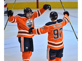Edmonton Oilers captain Connor McDavid celebrates with Leon Draisaitl after scoring a hit trick against the Calgary Flames during NHL season opener action at Rogers Place in Edmonton, October 4, 2017.
