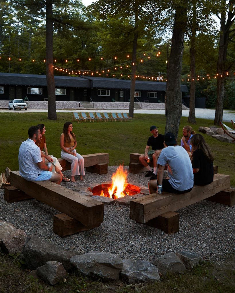 Guests congregate around a campfire at Somewhere Inn Calabogie
