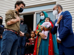 Prime Minister Justin Trudeau greets the Rahimi family (Ayat, Arezoo, Hawa, Obaidullah) who recently resettled in Ottawa from Afghanistan, in Ottawa, on October 9, 2021.