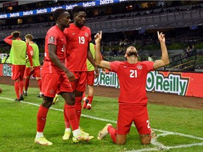 Canada's Jonathan Osorio (right) celebrates after scoring against Mexico during the Concacaf qualifying match for the Qatar 2022 FIFA World Cup Qatar at the Azteca Stadium in Mexico City on October 7, 2021.