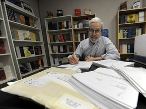 As founder and president of NeWest Press, Douglas Barbour reviews manuscripts in his Edmonton office.