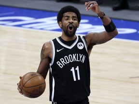 Brooklyn Nets guard Kyrie Irving (11) reacts during the third quarter against the Dallas Mavericks at the American Airlines Center.