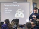 Financial education will be taught in all Ontario high schools in the fall.  In this Dec. 14, 2018 file photo, Sandwich High School student Christopher Lanno speaks with students at LaSalle Public School as part of a student-led initiative that aims to foster financial success. future.