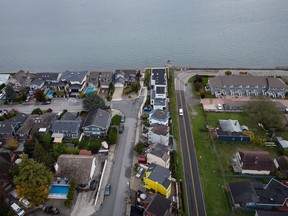 The houses in Boundary Bay in Delta, left, and Point Roberts, Washington, right, are separated by the Canada-US border, which is just north of Roosevelt Way, in the center, at Point Roberts, as seen seen in an aerial view on Wednesday in October.  13, 2021. Point Roberts is located on a peninsula and can only be accessed by land traveling through Canada.