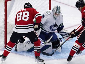 Vancouver Canucks goalkeeper Thatcher Demko (35) saves a shot from Chicago Blackhawks right wing Patrick Kane, left, during the first period of an NHL hockey game in Chicago on Thursday, February 21. October 2021.