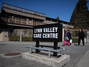 Workers arrive at the Lynn Valley Care Center senior facility in North Vancouver, BC on Saturday, March 14, 2020.