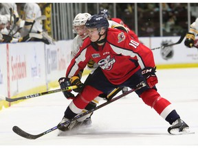 Daniil Sobolev (10) of Windsor Spitfires checks on Nolan Dann of Sarnia Sting in the first period at the Progressive Auto Sales Arena in Sarnia on Friday.
