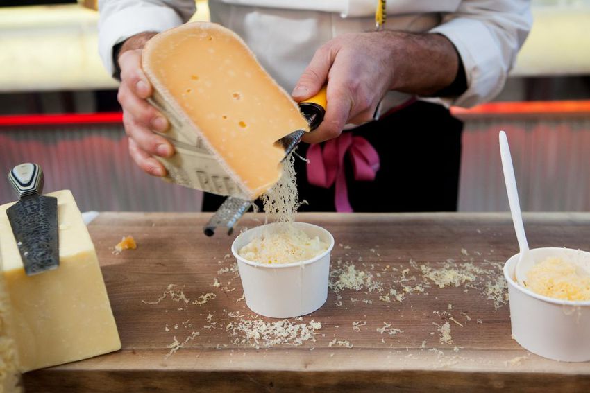 Cheese Boutique owner Afrim Pristine puts Beemster on his Tri-Cheese Mac and Cheese, which is now available at the Scotiabank Arena.  Pictured is sample size for preview, Pristine says actual portion is larger.