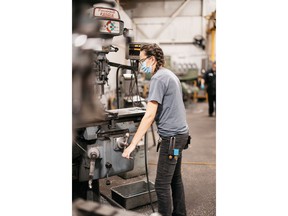 This is Rebecca Chenier operating a vertical hand mill Photo Credit: Build a Dream / Heike Delmore