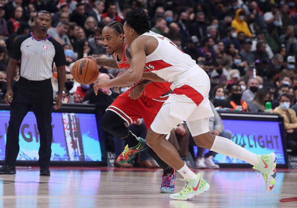 The Bulls' DeMar DeRozan tries to overtake Raptors rookie Scottie Barnes in Monday night's game at Scotiabank Arena.  DeRozan finished with 26 points in his second game in Toronto as an opponent.