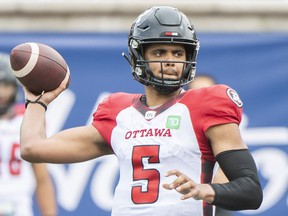 Ottawa Redblacks quarterback Caleb Evans throws a pass during the first half of CFL soccer action against the Montreal Alouettes in Montreal, Monday, Oct. 11, 2021.