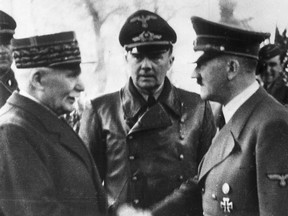 This file photo from October 24, 1940 shows German Chancellor Adolf Hitler, right, shaking hands with Vichy France's head of state, Marshal Philippe Petain, in occupied France.