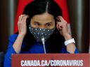 Canada's director of public health, Dr. Theresa Tam, dons a mask at a press conference.