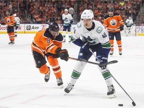 Elias Pettersson (40) of the Vancouver Canucks and Kyle Turris (8) of the Edmonton Oilers battle for the puck during the first period of NHL action in Edmonton on Wednesday.