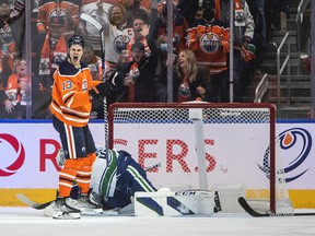 Vancouver Canucks goalkeeper Thatcher Demko (35) is scored by Jesse Puljujarvi (13) of Edmonton Oilers during NHL's first period of action in Edmonton on Wednesday.