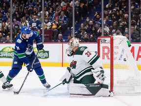 Alex Chiasson (39) of the Vancouver Canucks scores against Minnesota Wild goalie Cam Talbot (33) during the second period of an NHL hockey game in Vancouver, Tuesday, Oct. 26, 2021.