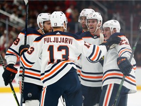 October 21, 2021;  Glendale, Arizona, United States;  Edmonton Oilers center Connor McDavid (97) celebrates his goal against the Arizona Coyotes with teammates on the ice during the second period at Gila River Arena.  Mandatory Credit: Mark J. Rebilas-USA TODAY Sports