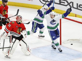 Vancouver Canucks forward Matthew Highmore (15) celebrates a Jason Dickinson (not pictured) goal against the Chicago Blackhawks during the first period at the United Center.