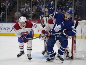 Canadiens defender Kaiden Guhle (21) and Maple Leafs forward Kirill Semeyonov (94) battle for position during the first period at Scotiabank Arena in Toronto on October 5, 2021.