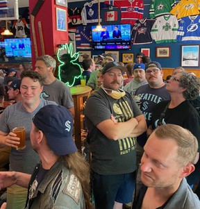 Kraken hockey fans inside the Angry Beaver bar in Seattle, Washington, viewing the 2021 NHL expansion draft.