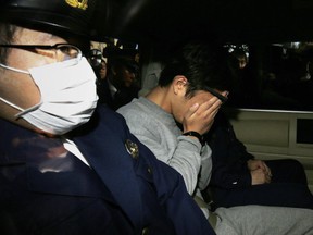 Suspected serial killer Takahiro Shiraishi is taken away by the police.  Prosecutors want him to be hanged.  THE ASSOCIATED PRESS