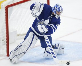 Toronto Maple Leafs Jack Campbell makes a save and shoots the puck on the ice during second period action in Toronto on May 6, 2021.