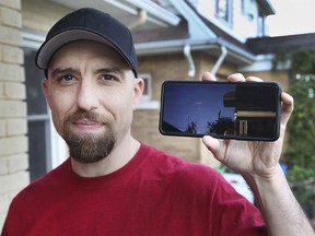 Shawn Bastien shows a video on his cell phone on Thursday, October 21, 2021, of a possible meteor that flew over the skies over Windsor recently.