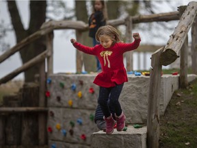 Charlotte Bedal, 6, of Natural Pathways Forest and Nature School, jumps out of the new Enbridge Natural Playground at the Holiday Beach Conservation Area in Amherstburg, Wednesday, Oct. 27, 2021.