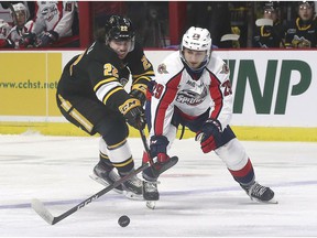 WINDSOR, ONTARIO.  OCTOBER 7, 2021 - Justin O'Donnell, left, of Sarnia Sting and Daniel D'Amico of Windsor Spitfires battle for the puck on Thursday, October 7, 2021 at the WFCU Center.
