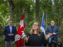 Karina Gould, Minister for International Development, is flanked by Irek Kusmiercyzk, MP for Windsor-Tecumseh, left, and Windsor Mayor Drew Dilkens, as she announces the signing of a collaborative statement to explore the potential of a national urban park in the Ojibway Prairie Complex, Monday, Aug.9, 2021.