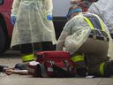 EMS paramedics and Windsor firefighters are shown on May 28, 2020, working on a man suspected of having suffered a fentanyl overdose as he lies on the sidewalk east of downtown.