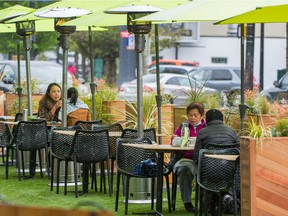Customers eat on the patio of a Vancouver restaurant.