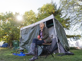 Athena Pranteau drinks her coffee outside her tent at CRAB Park in Vancouver, BC, October 10, 2021.