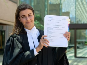 Animal rights lawyer Rebeka Breder holds a petition, challenging the wolf killing program, outside the British Columbia Supreme Court in Vancouver.