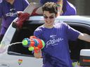 WINDSOR, ON.  August 11, 2019 - Jayden Lacoursiere of the Arts Collective Theater group uses a squirt gun to spray people during the Windsor-Essex Pride Parade on Ottawa St. on Sunday, August 11, 2019.