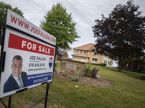 A 'for sale' sign is seen on the lawn of a home on Riverside Drive East in Riverside, Friday, Sept. 3, 2021.