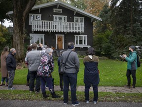 Walter Petrichyn of the Windsor Museum leads the Riverside History Walking Tour on Riverside Drive East on October 30, 2021.