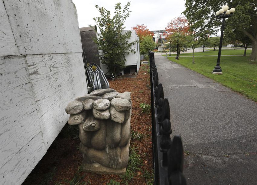 A statue of Hydra stands between two fences.  20 sculptures are enclosed behind fences at the Toronto Events Center, formerly called Muzik on the CNE grounds on Dufferin and Saskatchewan highways.  Kathy Sutton, daughter of the iconic Canadian sculptor EB Cox, finally secured the relocation of her father's masterpiece back to public view.