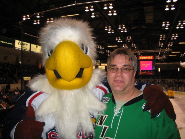 Longtime London Knights fan Rob Matic poses with Sammy Spirit during a game hosted by the Saginaw Spirit.