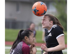 Kayla Noguiera, left, of Wallaceburg, and Megan Bornais of L'Essor battle for the ball during the SWOSSAA Girls' AA Soccer Final on Wednesday May 29, 2019, at Holy Names High School in Windsor.  Restrictions prohibiting extracurricular activities in Windsor-Essex have been lifted.