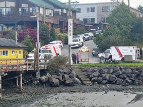 Ambulances waiting on the ground to attend to passengers rescued from the Tofino Air seaplane that was involved in a collision with a water taxi on Monday in the port of Tofino.