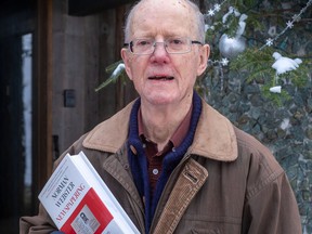 Norman Webster, seen in January 2021 with his book Newspapering: 50 Years of Reporting From Canada and Around the World, 