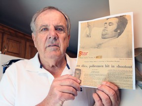 Retired Windsor Police Officer Bill Glen, 76, shows the cover of the Windsor Star the day after he and his partner William Pheby were shot and wounded by a gunman in 1973. Incredibly, the Windsor Star photographer , Cec Southward, took a photograph of the wounded Pheby.  on a Met Hospital bed and the story included the names of both officers and the deceased gunman.  Glen passed away on November 11.