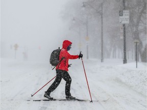 A cross-country skier crosses Park Ave. during a snowstorm in Montreal.